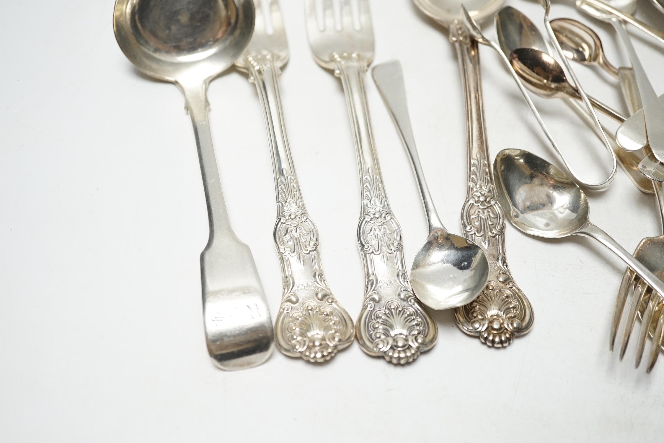 Sundry silver cutlery, including a pair of Victorian Kings pattern table forks and a matching tablespoon, London, 1845, a William IV fiddle pattern sauce ladle and various salt, tea and coffee spoons, 21.9oz and three pl